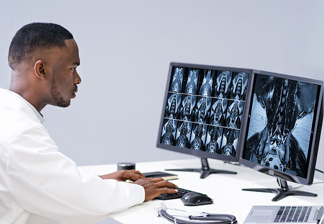 Physican looking at spinal MRI results